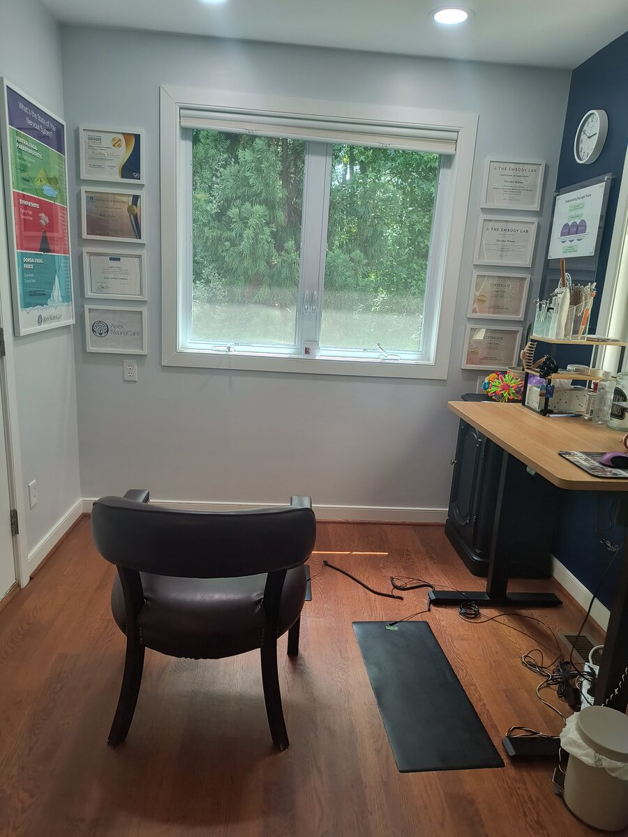 Wall of framed certificates and continuing-education credentials in Heather's office